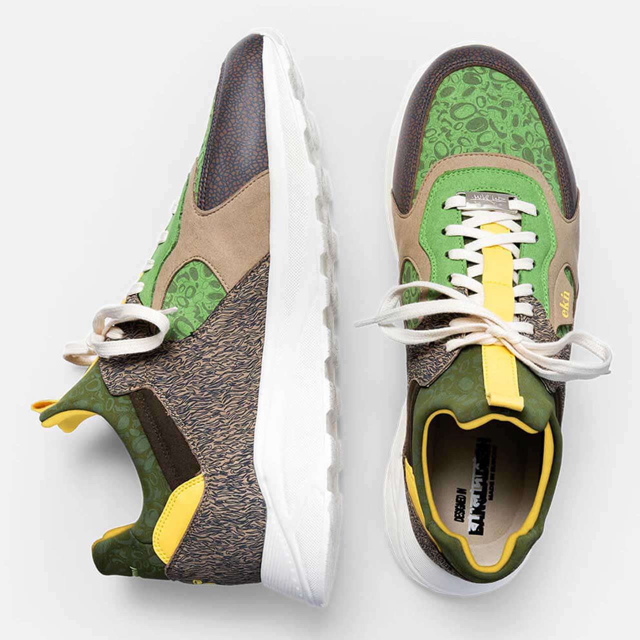 Overhead view of a Kamthala sneaker pair, one on its side to show the white sole.