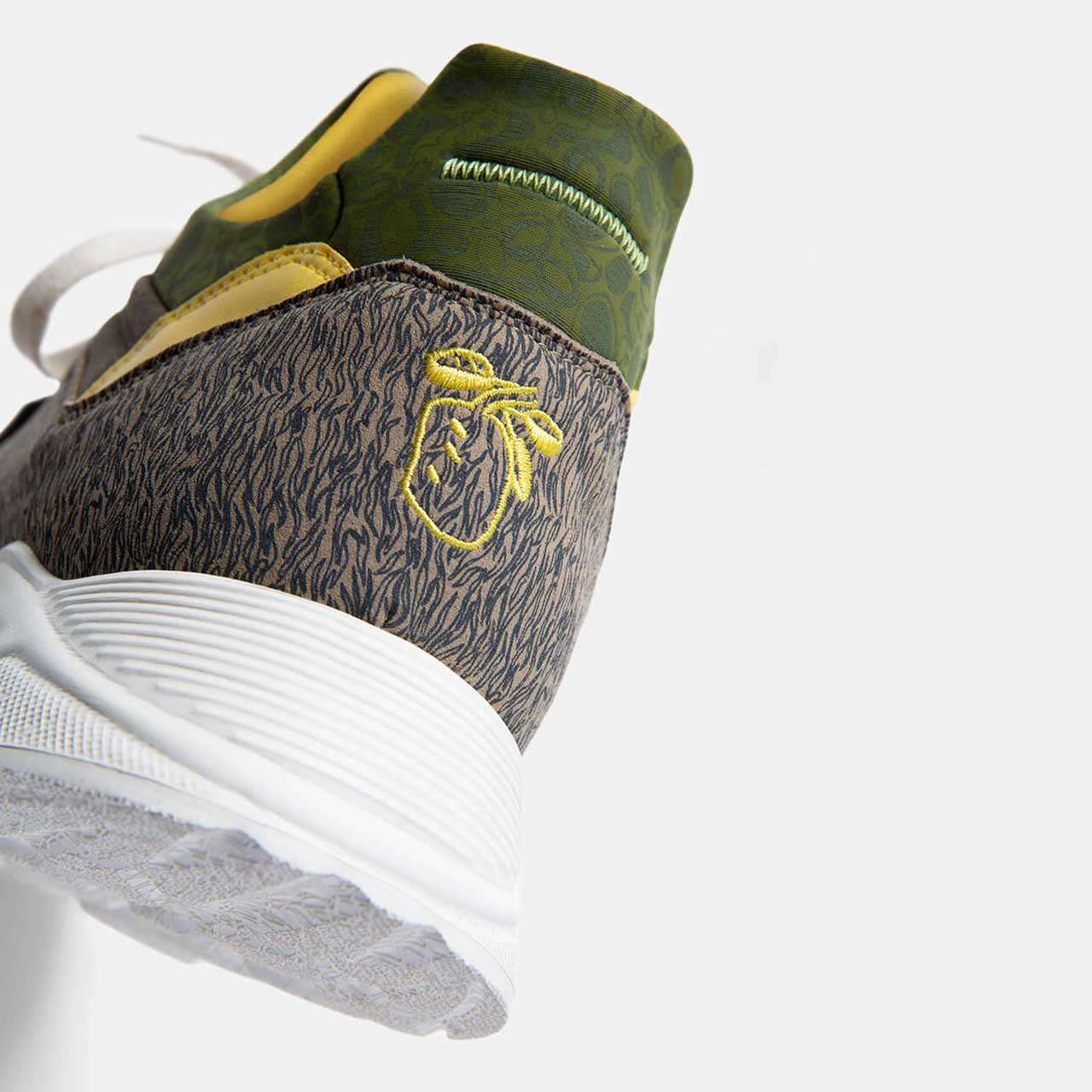 Heel close-up of a Kamthala sneaker with yellow jackfruit embroidery.